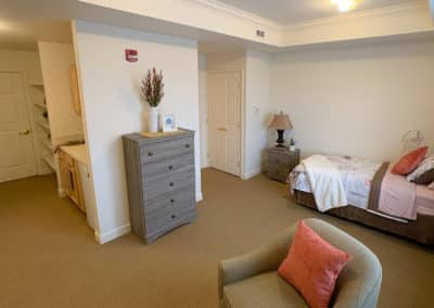 Bedroom with bed, dresser and chair